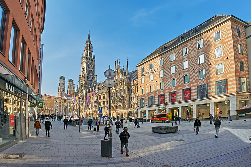 Munich, Germany - March 08, 2021: only a few pedestrians cross Mareinplatz in times of Corona.