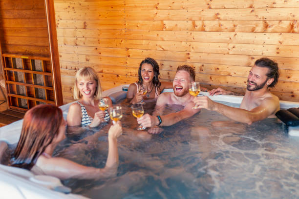 istock Friends making a toast and relaxing in a hot tub while on a vacation 1307381030