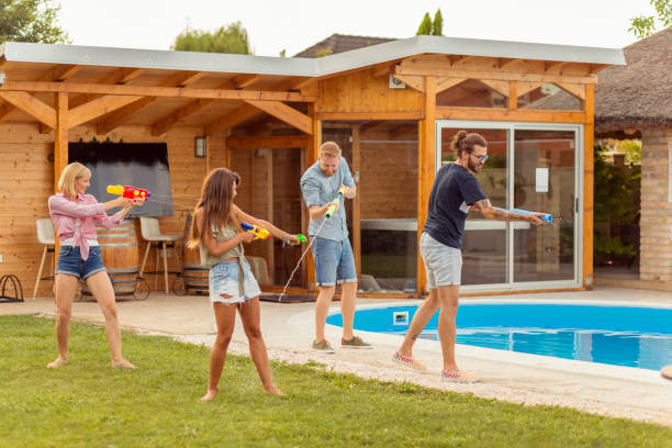 istock Friends having a squirt guns war 1307381134