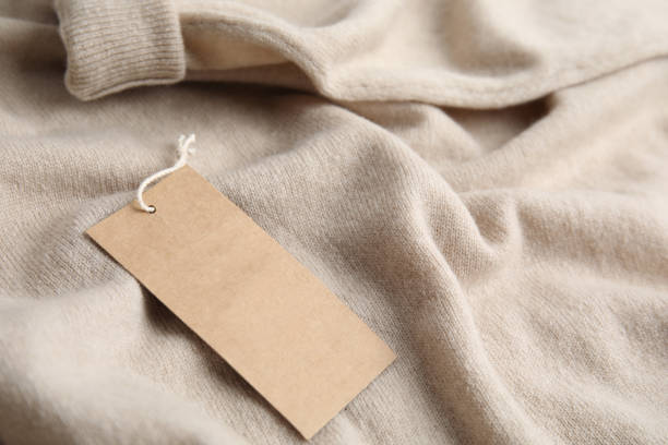 istock Warm beige cashmere sweater with tag, closeup 1307381252
