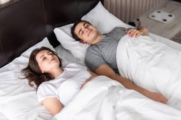 istock Young young cute couple sleeping together in bed 1307381446