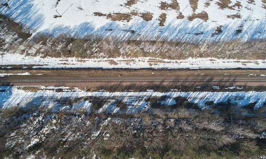 Empty railroad line above drone view on winter snow spot landscape