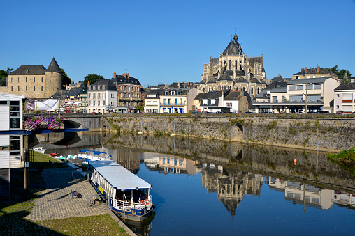 River in the town of Mayenne with Notre-Dame basilica and the castle, commune in the Mayenne department in north-western France