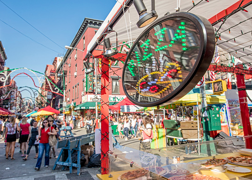 New York, USA - Sept 18th, 2015: Food vendor selling Italian food in Little Italy on Mulberry St. during the Feast Of San Gennaro. Focus is on the Pizza sign.