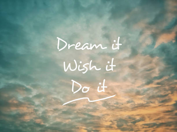 Dream it wish it do it text with sunset sky background. Stock photo.