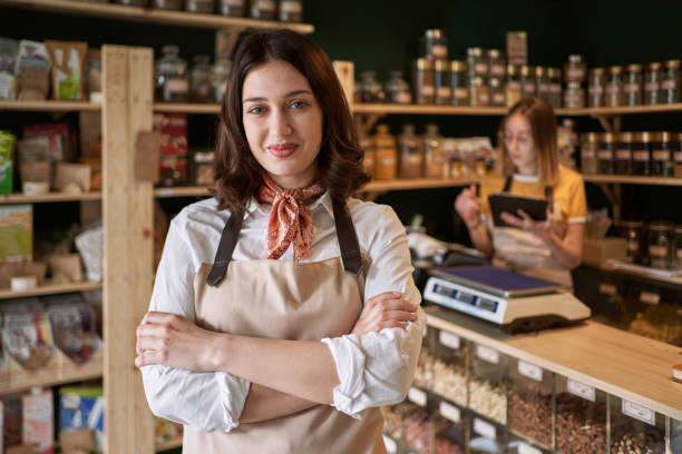 istock While employee doing the inventory checklist, charming female owner can't hide her pride of the success of her health food shop 1307388847