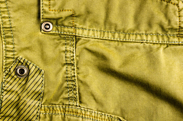 istock clothing items stonewashed cotton fabric texture with seams, clasps, buttons and rivets, macro 1307389751