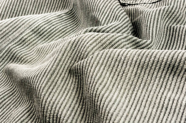 istock clothing items stonewashed cotton fabric texture with seams, clasps, buttons and rivets, macro 1307389753