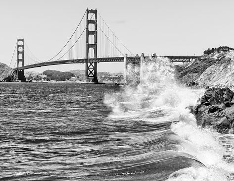 Dramatic scene of pacific waves crashing in front of the Golden Gate Bridge