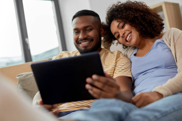 istock happy couple with tablet pc computer at new home 1307391626