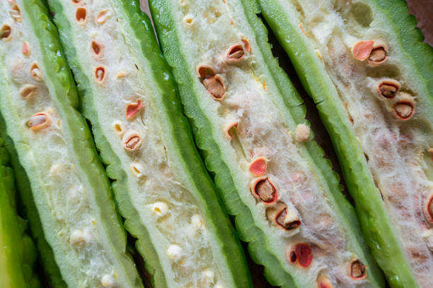 Cut bitter gourd on wooden kitchen board
