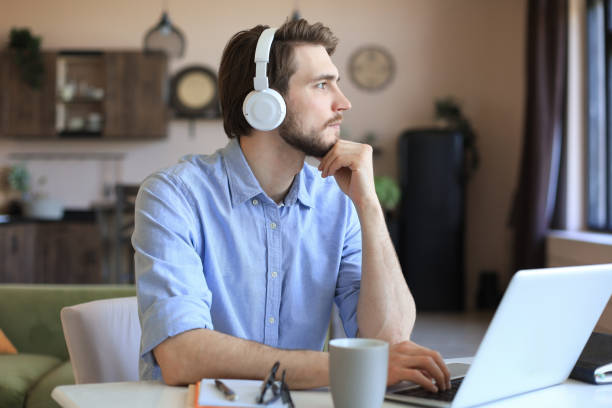 istock Confident man wearing headset speaking and watching business webinar training, listening to lecture. 1307392677