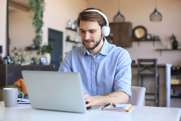 istock Confident man wearing headset speaking and watching business webinar training, listening to lecture. 1307392698