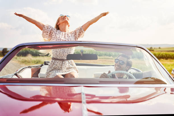 istock Front view of happy young people in a cabriolet 1307392844