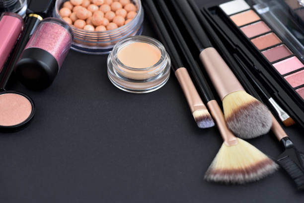 istock Makeup brush and decorative cosmetics on black background 1307394188