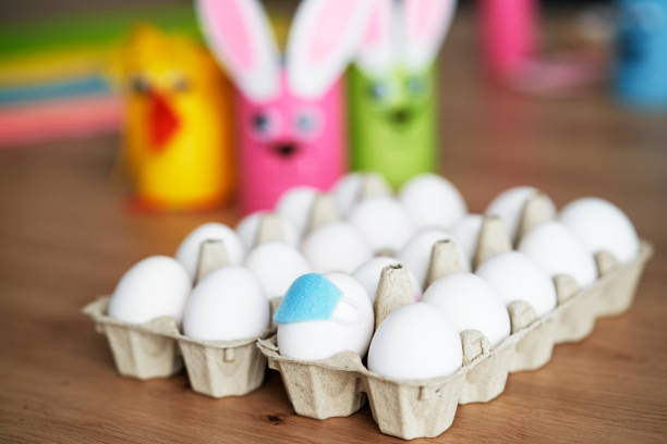 istock Close up of egg with face masks in a cardboard box 1307394388