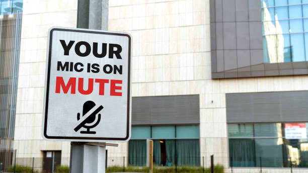 istock Your mic is on mute sign in a downtown city setting 1307396112