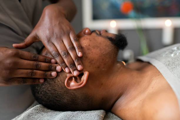 istock Masseuse giving head massage to man in spa 1307396733