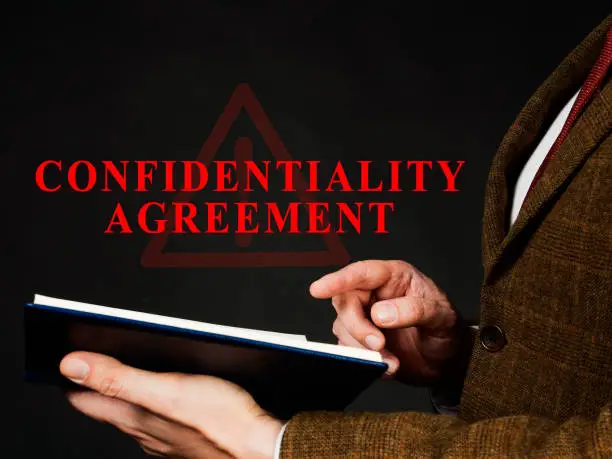 Photo of Non-disclosure or Confidentiality agreement in the red folder.