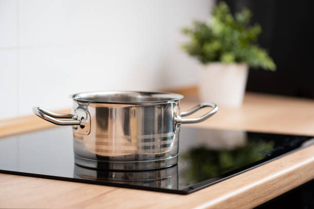 istock Pot in the kitchen on the induction hob 1307397389
