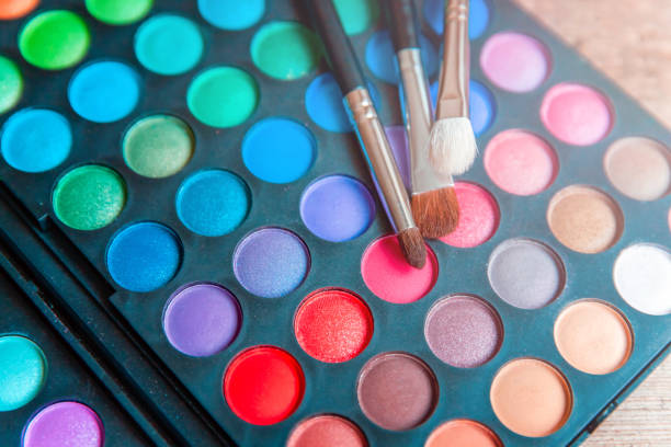 istock Makeup tools eyeshadow palette and brushes on wooden background 1307397511