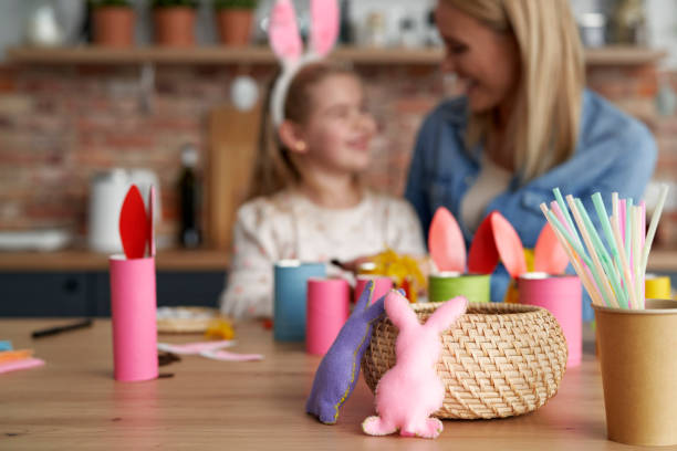 istock Handmade Easter rabbits and mom and daughter in the background 1307398138