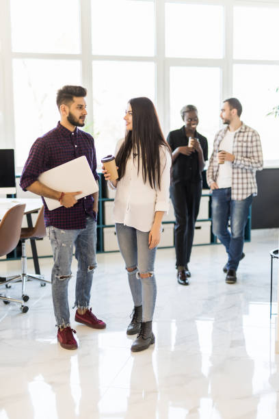 istock Young modern colleagues on coffee break in front of the modern office 1307399086