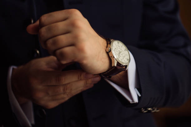 The man wears watches The The man in the white shirt in the window wears watches cufflink stock pictures, royalty-free photos & images