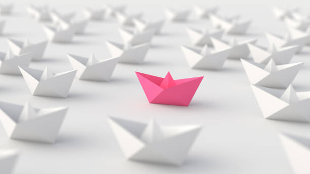 Woman leadership concept, pink leader boat, standing out from the crowd of white boats, on white background stock photo