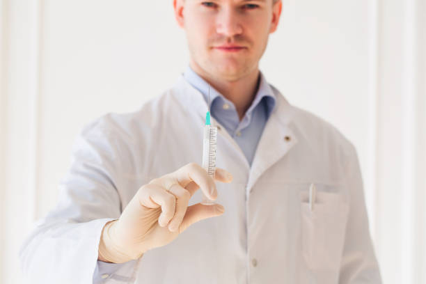 istock Doctor syringe with injection 1307400144