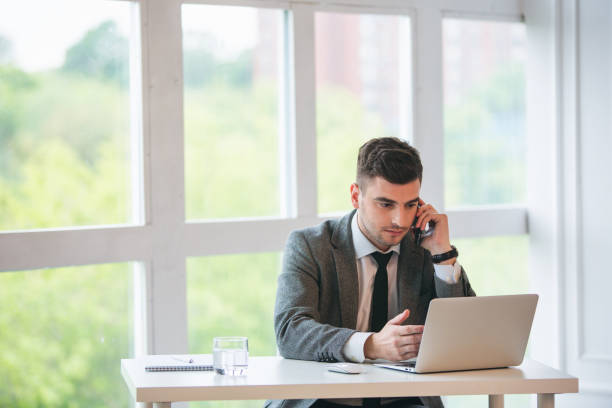 Businessman is talking by phone in a office