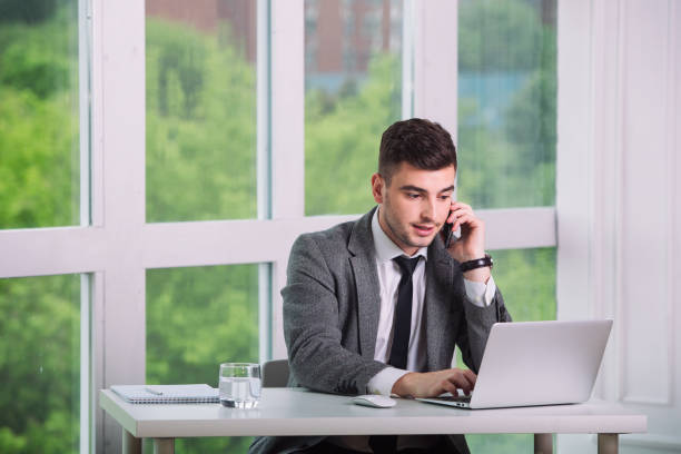 istock Businessman is talking by phone in a office 1307401019