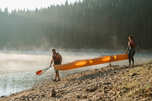 istock Young couple ready for adventures with kayak. 1307401736