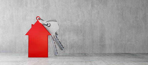 Red house symbol with silver door keys in concrete modern interior