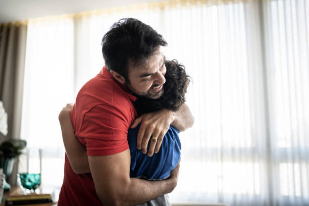 istock Father and son embracing at home 1307403080