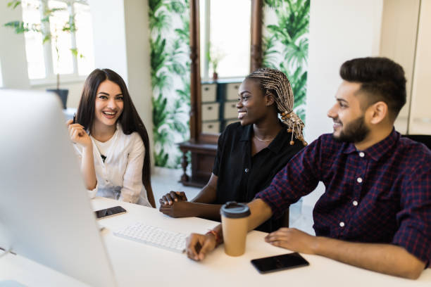 istock Young international business team working together on a creative idea, Young people discussing new business project in office. 1307405113