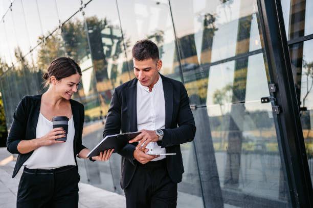 istock Business man and woman discussing work on the go 1307406628