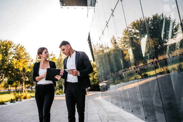 istock Business man and woman discussing work on the go 1307406685