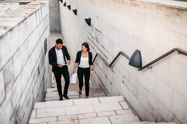 istock Business man and woman discussing work on the go 1307407852