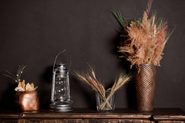 istock Wooden shelf with different home related objects on the dark wall background 1307407978