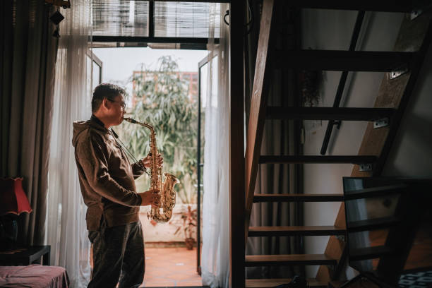istock lifehack asian chinese mature man practicing saxophone at home during weekend leisure time 1307408069