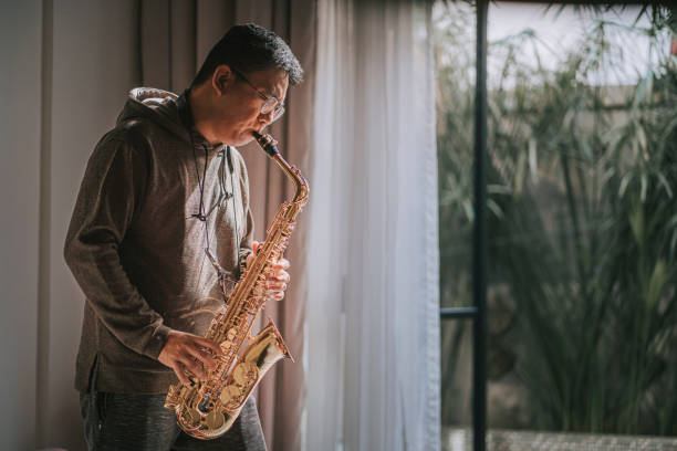 istock lifehack asian chinese mature man practicing saxophone at home during weekend leisure time 1307408072