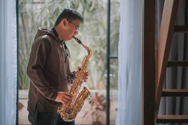 istock lifehack asian chinese mature man practicing saxophone at home during weekend leisure time 1307408103