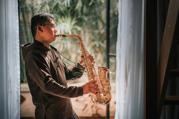 istock lifehack asian chinese mature man practicing saxophone at home during weekend leisure time 1307408120