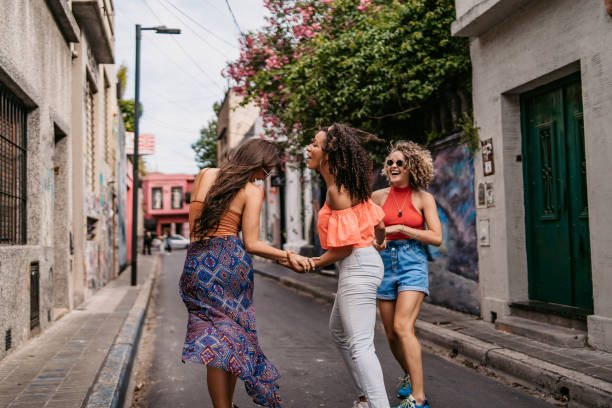 istock Three young women walking and dancing 1307408502