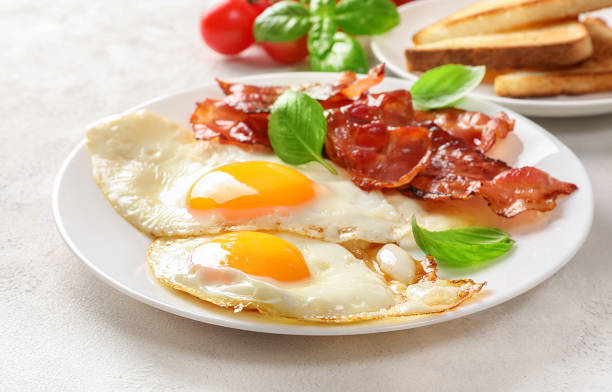 istock Traditional american breakfast with bacon and eggs 1307409131
