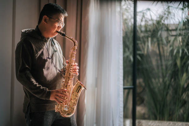 istock lifehack asian chinese mature man practicing saxophone at home during weekend leisure time 1307409509