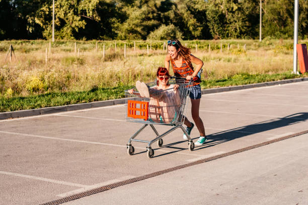 istock Two women  riding shopping cart 1307409784