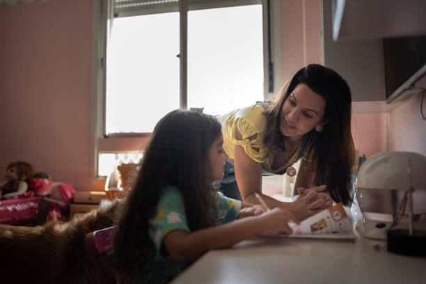 istock Mother helping daughter with homeschooling 1307409849
