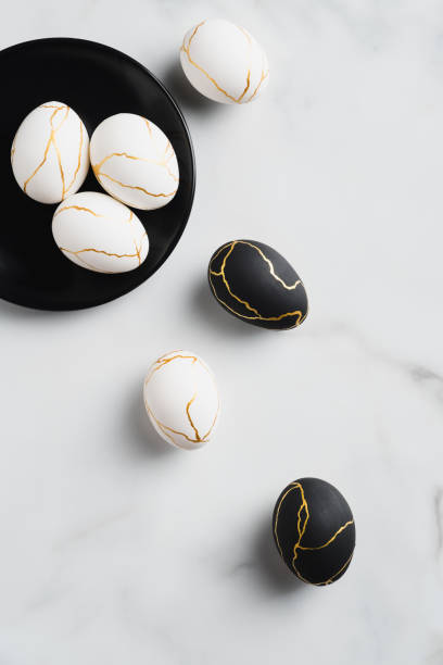 istock White and black Easter eggs decorated gold on marble table. Flat lay, top view. Happy Easter card. 1307409927